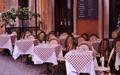 Tables et chaises disposées devant un restaurant avec menu affiché